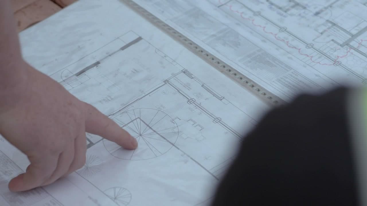 Homeowner reviewing contractor documents and license verification in Anaheim